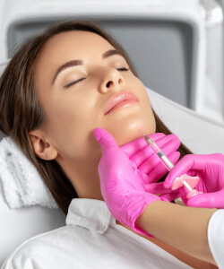 woman receiving chin filler at capital aesthetics